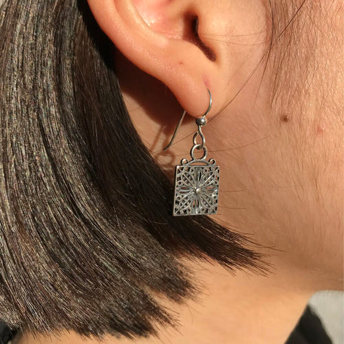 small davenport house earrings on model